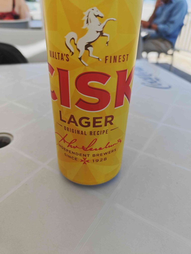 Can of Cisk lager sat on our table at a small kiosk in St Paul's Bay