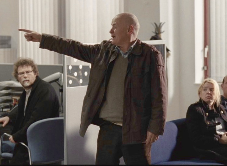 I, Daniel Blake review: Still one of the most quietly devastating British films around 2 I, Daniel Blake - Daniel standing up and pointing in the Job Centre